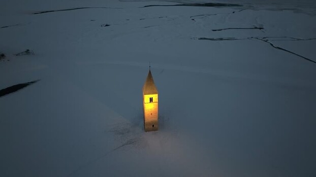 Aerial view of the sunken church tower in Graun im Vinschgau Italy. Aerial view of the sunken church tower in Graun im Vinschgau Italy.