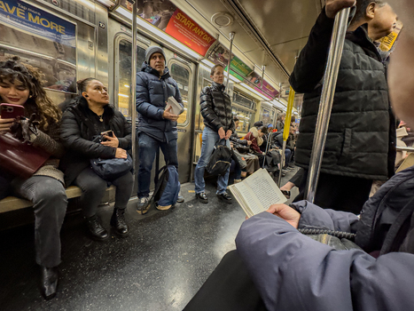 New York United States 14 May 2026 View of passengers commuting inside a subway car with people sitting standing and reading books amidst advertisements. New York United States 14 May 2026 View of passengers commuting inside a subway car with people sitting standing and reading books amidst advertisements.