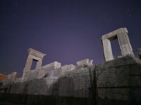 View of the ancient stone ruins under a deep blue star speckled sky a timeless scene of Persepolis architectural heritage Marvdasht Fars Province Iran.