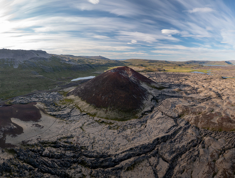 Aerial view of Ytri Raudarmelskula volcanic crater surrounded by rugged lava fields and mossy terrain under a vast sky Raudhamelur Eyja og Miklaholtshr Iceland. Aerial view of Ytri Raudarmelskula volcanic crater surrounded by rugged lava fields and mossy terrain under a vast sky Raudhamelur Eyja og Miklaholtshr Iceland.