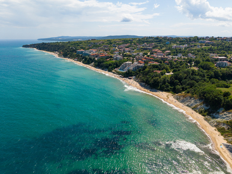 Aerial view of the coastline of Byala with sandy beaches turquoise sea lush green hills and residential buildings in Byala Varna Bulgaria. Aerial view of the coastline of Byala with sandy beaches turquoise sea lush green hills and residential buildings in Byala Varna Bulgaria.