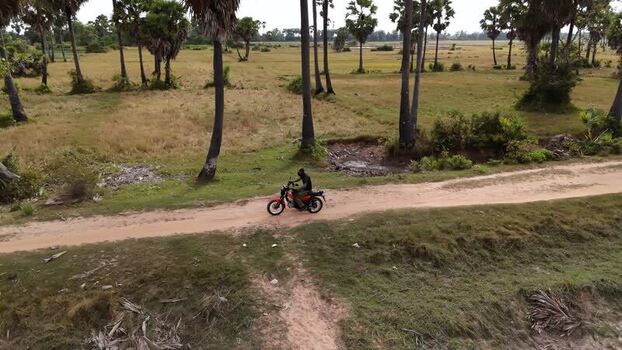 Aerial view of a motorcyclist on a dirt road Cambodia. Aerial view of a motorcyclist on a dirt road Cambodia.