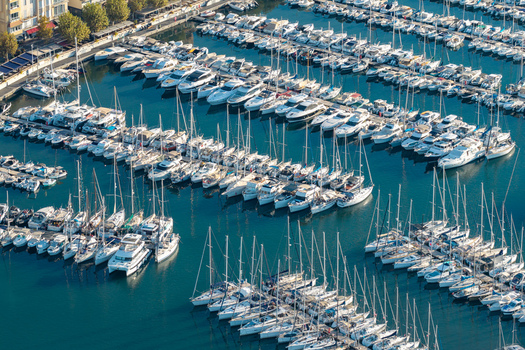 Aerial view of the marina in Antibes filled with numerous yachts and sailboats moored in the harbor showcasing the coastal infrastructure in Antibes Provence Alpes Cote d Azur France. Aerial view of the marina in Antibes filled with numerous yachts and sailboats moored in the harbor showcasing the coastal infrastructure in Antibes Provence Alpes Cote d Azur France.