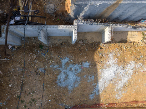 Aerial view of a construction site showing concrete foundation walls exposed earth and construction materials in Istanbul Istanbul Turkiye.