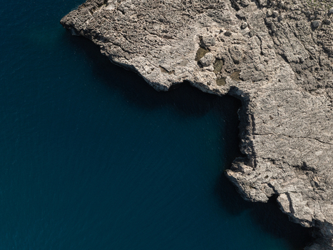 Aerial view of the rugged limestone cliffs and deep blue Mediterranean waters of the Plemmirio Marine Protected Area Plemmirio Sicily Italy. Aerial view of the rugged limestone cliffs and deep blue Mediterranean waters of the Plemmirio Marine Protected Area Plemmirio Sicily Italy.