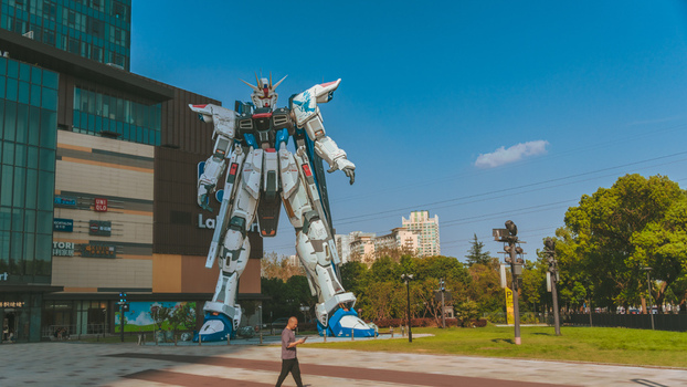 View of the giant Gundam statue standing in front of the Lalaport shopping mall under a clear blue sky in Shanghai Shanghai China.