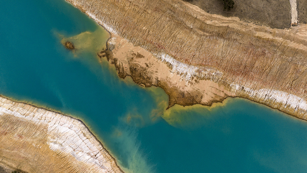 Aerial view of turquoise salt mine waters contrasting with textured sandy banks and industrial earth patterns Kalbarri Western Australia Australia. Aerial view of turquoise salt mine waters contrasting with textured sandy banks and industrial earth patterns Kalbarri Western Australia Australia.