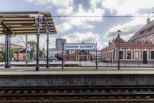 Gdansk Poland 06 September 2026 View of the historic Gdansk Glowny railway station platform with its distinctive red brick architecture overhead power lines and blue sky. Gdansk Poland 06 September 2026 View of the historic Gdansk Glowny railway station platform with its distinctive red brick architecture overhead power lines and blue sky.