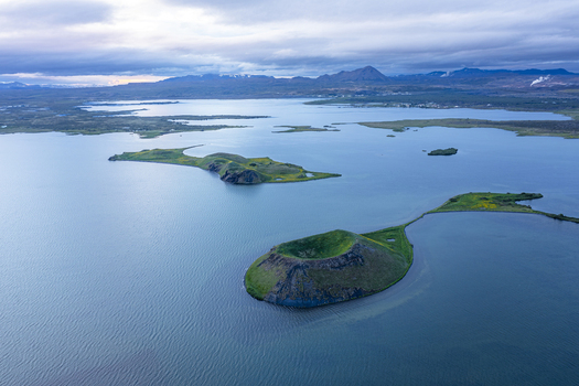 Aerial view of Lake Myvatn with its volcanic craters and islands surrounded by water in Thingeyjarsveit Iceland.