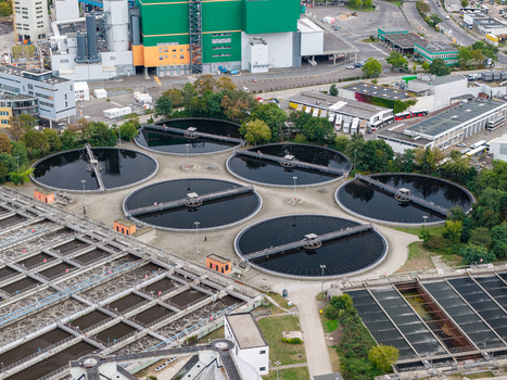 Aerial view of the Klarwerk Ruhleben wastewater treatment plant featuring large circular sedimentation tanks and industrial infrastructure in Berlin Berlin Germany.