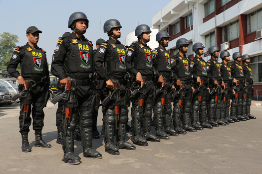 Dhaka Bangladesh 08 January 2017 View of Rapid Action Battalion RAB officers in black tactical gear and helmets standing in formation with rifles outside the RAB Headquarters. Dhaka Bangladesh 08 January 2017 View of Rapid Action Battalion RAB officers in black tactical gear and helmets standing in formation with rifles outside the RAB Headquarters.