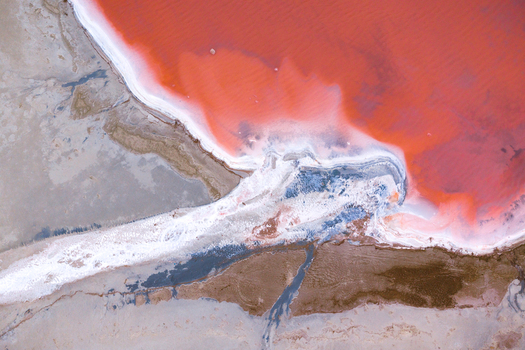 Aerial view of stark white salt flats meet vibrant pink waters creating a surreal contrast of textures and tones City Name Country Name . Aerial view of stark white salt flats meet vibrant pink waters creating a surreal contrast of textures and tones City Name Country Name .