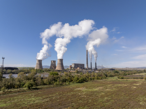Aerial view of the Bobov Dol Power Plant with cooling towers emitting steam against a clear blue sky surrounded by rural landscape in Golemo Selo Kyustendil Province Bulgaria. Aerial view of the Bobov Dol Power Plant with cooling towers emitting steam against a clear blue sky surrounded by rural landscape in Golemo Selo Kyustendil Province Bulgaria.