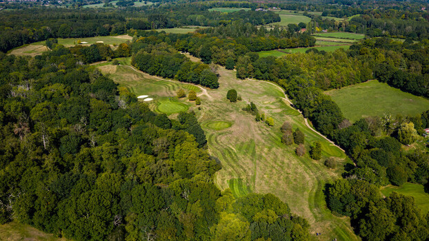 Aerial view of Hamptworth Golf course featuring lush green fairways sand bunkers and surrounding dense woodland in Hamptworth England United Kingdom. Aerial view of Hamptworth Golf course featuring lush green fairways sand bunkers and surrounding dense woodland in Hamptworth England United Kingdom.