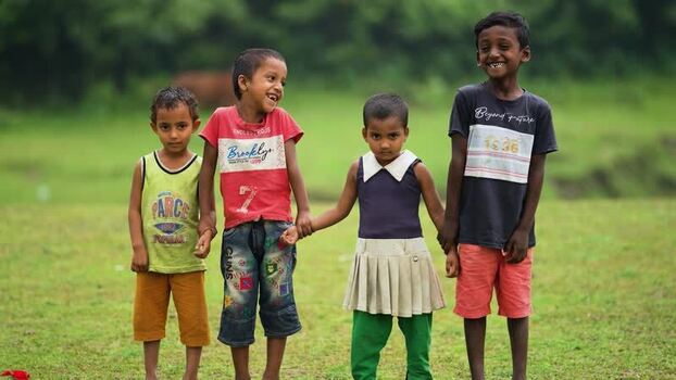 View of children holding hands in a green field Bangladesh. View of children holding hands in a green field Bangladesh.