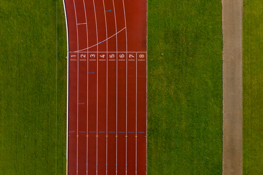Aerial view of the red running track at Sport Island Forchheim with numbered lanes and green grass Forchheim Bavaria Germany. Aerial view of the red running track at Sport Island Forchheim with numbered lanes and green grass Forchheim Bavaria Germany.