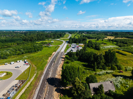 Aerial view of E67 Via Baltica road construction site surrounded by green fields trees and rural landscape in Lielvarzi Kekava Municipality Latvia. Aerial view of E67 Via Baltica road construction site surrounded by green fields trees and rural landscape in Lielvarzi Kekava Municipality Latvia.