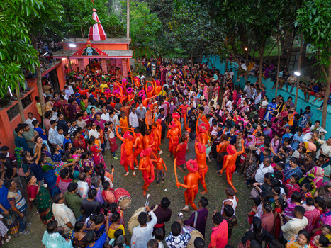 Munshiganj Bangladesh 13 April 2026 Aerial view of vibrant orange clad performers captivating a dense colorful crowd on the sacred ground of a temple.