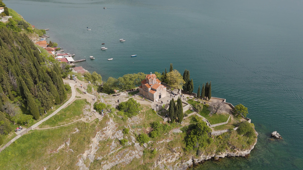 Aerial view of the Church of St. John at Kaneo on a cliff overlooking Lake Ohrid surrounded by cypress trees and greenery in Ohrid Municipality of Ohrid North Macedonia. Aerial view of the Church of St. John at Kaneo on a cliff overlooking Lake Ohrid surrounded by cypress trees and greenery in Ohrid Municipality of Ohrid North Macedonia.