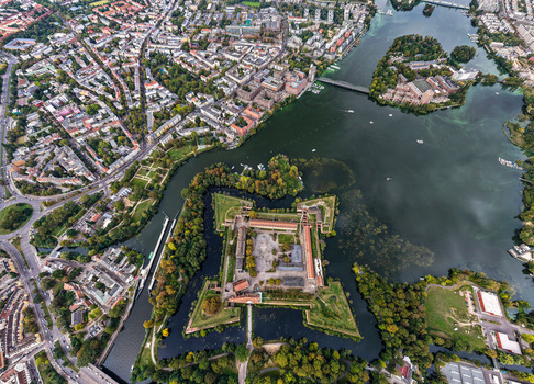 Aerial view of Spandau Citadel a historic star shaped fortress surrounded by water and lush greenery in the urban landscape of Berlin Berlin Germany.
