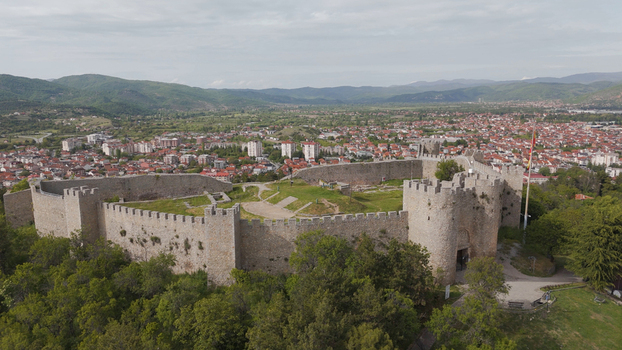 Aerial view of Samuel s Fortress surrounded by lush trees and stone walls overlooking the city of Ohrid and distant mountains in Ohrid Municipality of Ohrid North Macedonia. Aerial view of Samuel s Fortress surrounded by lush trees and stone walls overlooking the city of Ohrid and distant mountains in Ohrid Municipality of Ohrid North Macedonia.