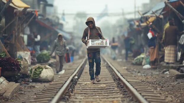 View of a man walking on railway tracks in Bogura Bangladesh. View of a man walking on railway tracks in Bogura Bangladesh.