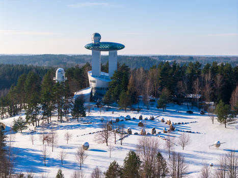Aerial view of the Lithuanian Museum of Ethnocosmology with its futuristic observatory tower surrounded by snow covered pine forests in Kulionys Utenos apskritis Lithuania.