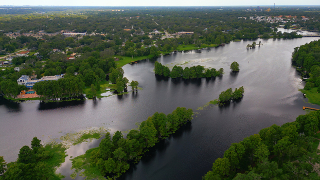 Aerial view of a serene lake with lush green islands and surrounding residential neighborhoods in Tampa Florida United States. Aerial view of a serene lake with lush green islands and surrounding residential neighborhoods in Tampa Florida United States.