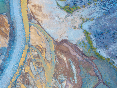 Aerial view of a riverbed with vibrant yellow sediment and rocky terrain in Colorado United States. Aerial view of a riverbed with vibrant yellow sediment and rocky terrain in Colorado United States.