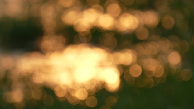 View of golden bokeh light reflecting on water in Bangladesh. View of golden bokeh light reflecting on water in Bangladesh.