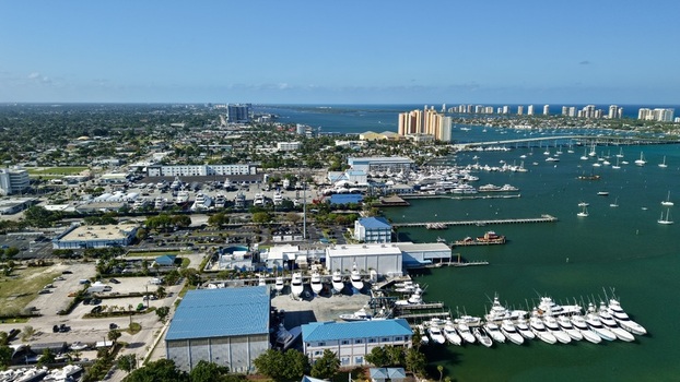 Aerial view of Riviera Beach Marina Village with numerous yachts docked in the harbor under a clear blue sky Riviera Beach Florida United States. Aerial view of Riviera Beach Marina Village with numerous yachts docked in the harbor under a clear blue sky Riviera Beach Florida United States.