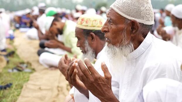 View of Muslim men performing Eid al Adha prayers Bangladesh. View of Muslim men performing Eid al Adha prayers Bangladesh.