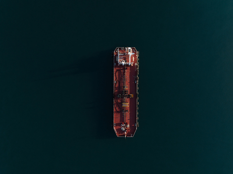 Aerial view of a large red industrial tanker ship floating on the calm dark blue sea surface Augusta Sicily Italy. Aerial view of a large red industrial tanker ship floating on the calm dark blue sea surface Augusta Sicily Italy.