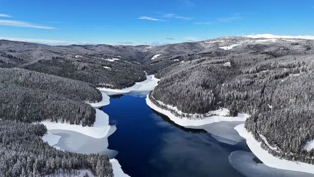 Aerial view of Soboth Reservoir and snow covered forests Austria. Aerial view of Soboth Reservoir and snow covered forests Austria.