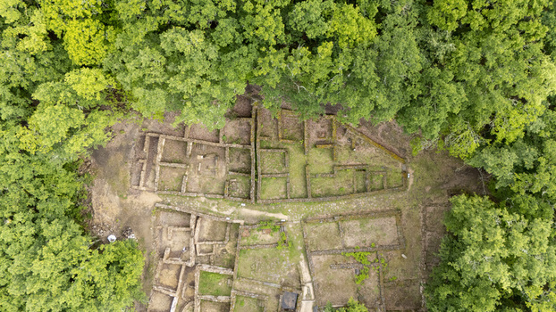 Aerial view of the ancient stone foundations of Castro de Armea surrounded by a dense green forest in Allariz Province of Ourense Spain. Aerial view of the ancient stone foundations of Castro de Armea surrounded by a dense green forest in Allariz Province of Ourense Spain.