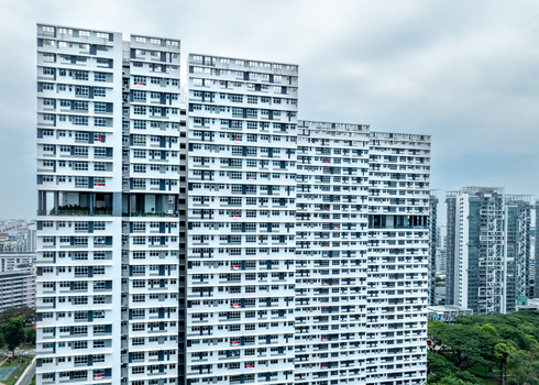 Aerial view of modern high rise residential apartment buildings with repetitive window patterns and balconies under a cloudy sky in Singapore Singapore. Aerial view of modern high rise residential apartment buildings with repetitive window patterns and balconies under a cloudy sky in Singapore Singapore.