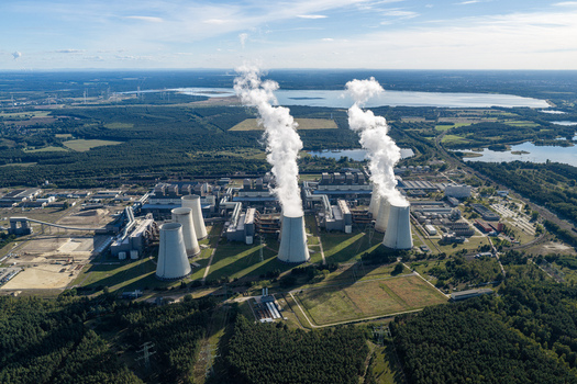 Aerial view of Janschwalde Power Station with its large cooling towers emitting steam plumes surrounded by extensive forests and lakes in Peitz Brandenburg Germany. Aerial view of Janschwalde Power Station with its large cooling towers emitting steam plumes surrounded by extensive forests and lakes in Peitz Brandenburg Germany.