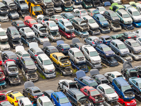 Aerial view of end of life vehicle recycling facility with rows of stacked cars and open hoods in a scrapyard Gdansk Pomeranian Voivodeship Poland.