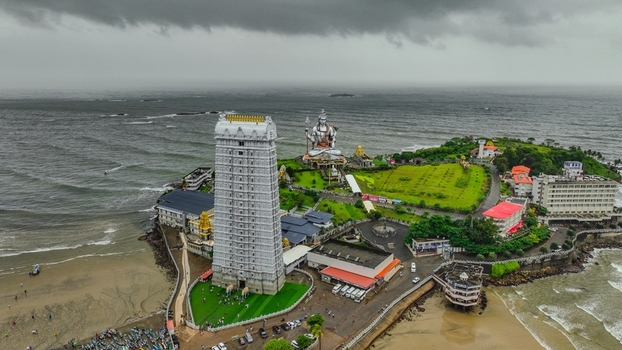 Aerial view of the Murudeshwar Temple featuring the towering Raja Gopura and the massive Shiva statue situated on the coast of the Arabian Sea in Murdeshwar Karnataka India.