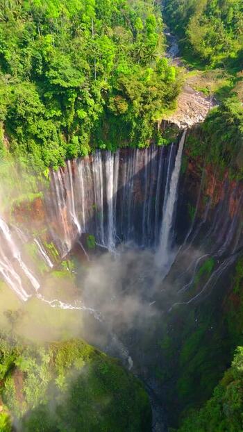 Aerial view of Tumpak Sewu Waterfall in the jungle Indonesia.