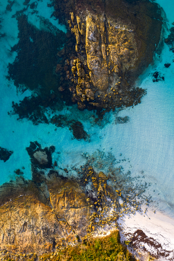 Aerial view of Goode Beach featuring turquoise waters rugged granite rock formations white sand and lush greenery in Albany Western Australia Australia.