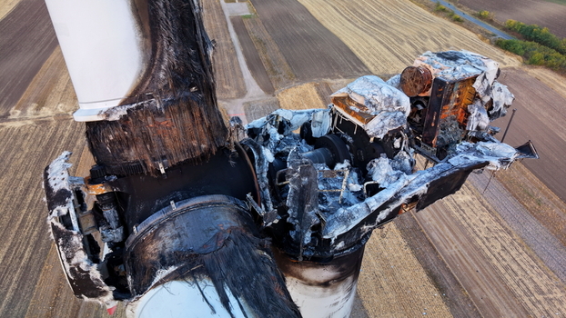 Aerial view of the fire damaged wind turbine nacelle showing charred blades and melted components in the fields of Vladimirovac Vojvodina Serbia.