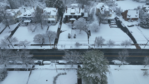Aerial view of the historic Rivermont neighborhood blanketed in fresh snow with residential houses and tree lined streets in Lynchburg Virginia United States.