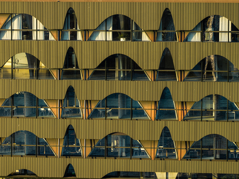 Aerial view of the distinctive arched facade of the Spreespeicher Promenade building featuring modern architectural design and warm lighting in Berlin Berlin Germany. Aerial view of the distinctive arched facade of the Spreespeicher Promenade building featuring modern architectural design and warm lighting in Berlin Berlin Germany.