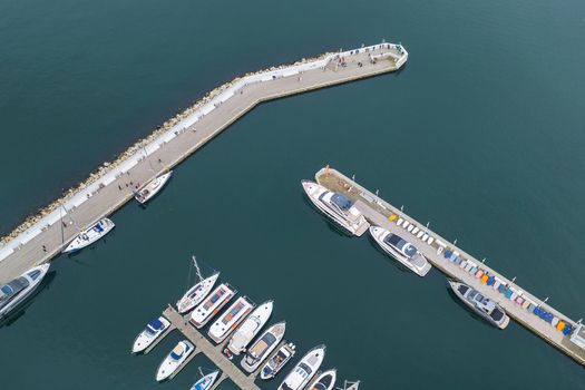 Aerial view of the marina with various yachts and boats moored along the pier in the Baltic Sea Sopot Pomeranian Voivodeship Poland. Aerial view of the marina with various yachts and boats moored along the pier in the Baltic Sea Sopot Pomeranian Voivodeship Poland.
