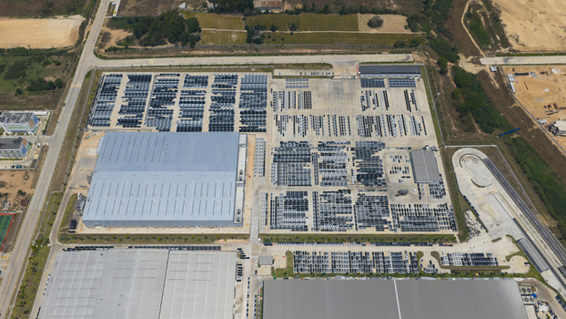 Aerial view of the BYD Thailand Rayong Office Building and extensive parking areas filled with rows of new cars in Phananikhom Rayong Thailand.