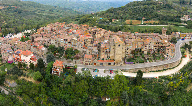 Aerial view of the historic hilltop village of Ficulle featuring stone houses and terracotta roofs surrounded by lush green hills in Ficulle Umbria Italy. Aerial view of the historic hilltop village of Ficulle featuring stone houses and terracotta roofs surrounded by lush green hills in Ficulle Umbria Italy.