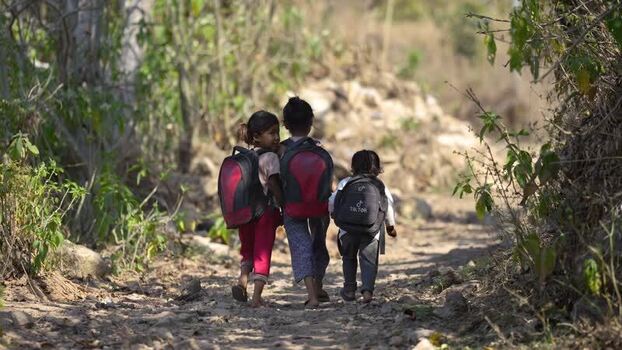 View of children walking on a rural path in Surkhet Nepal.