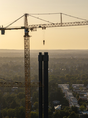 Aerial view of Combined Heat and Power Plant Lichterfelde during deconstruction with tall cranes and industrial chimneys against a golden sunset sky in Berlin Berlin Germany. Aerial view of Combined Heat and Power Plant Lichterfelde during deconstruction with tall cranes and industrial chimneys against a golden sunset sky in Berlin Berlin Germany.