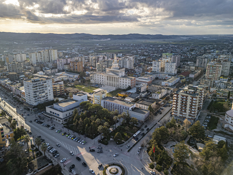 Fier Fier County Albania 18 January 2026 Aerial view of the University of Fier surrounded by urban architecture residential buildings and streets under a cloudy sky.